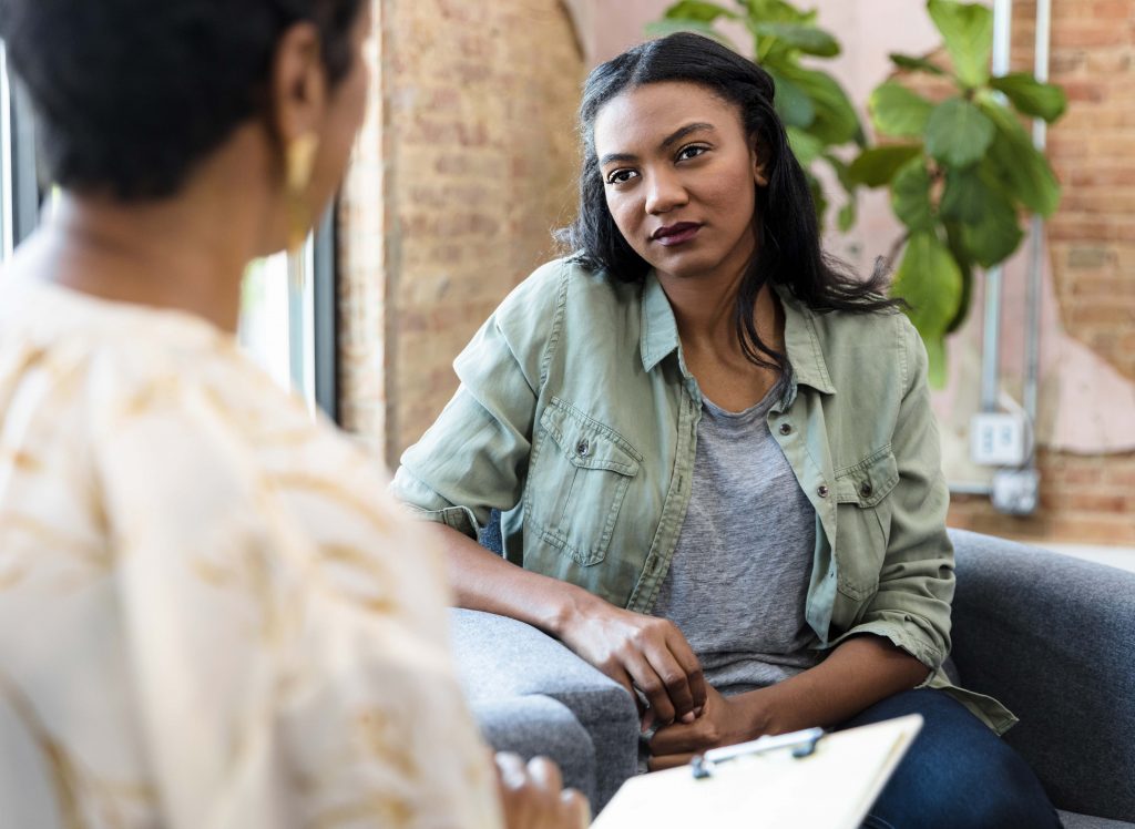 Young woman talking with Social Worker.