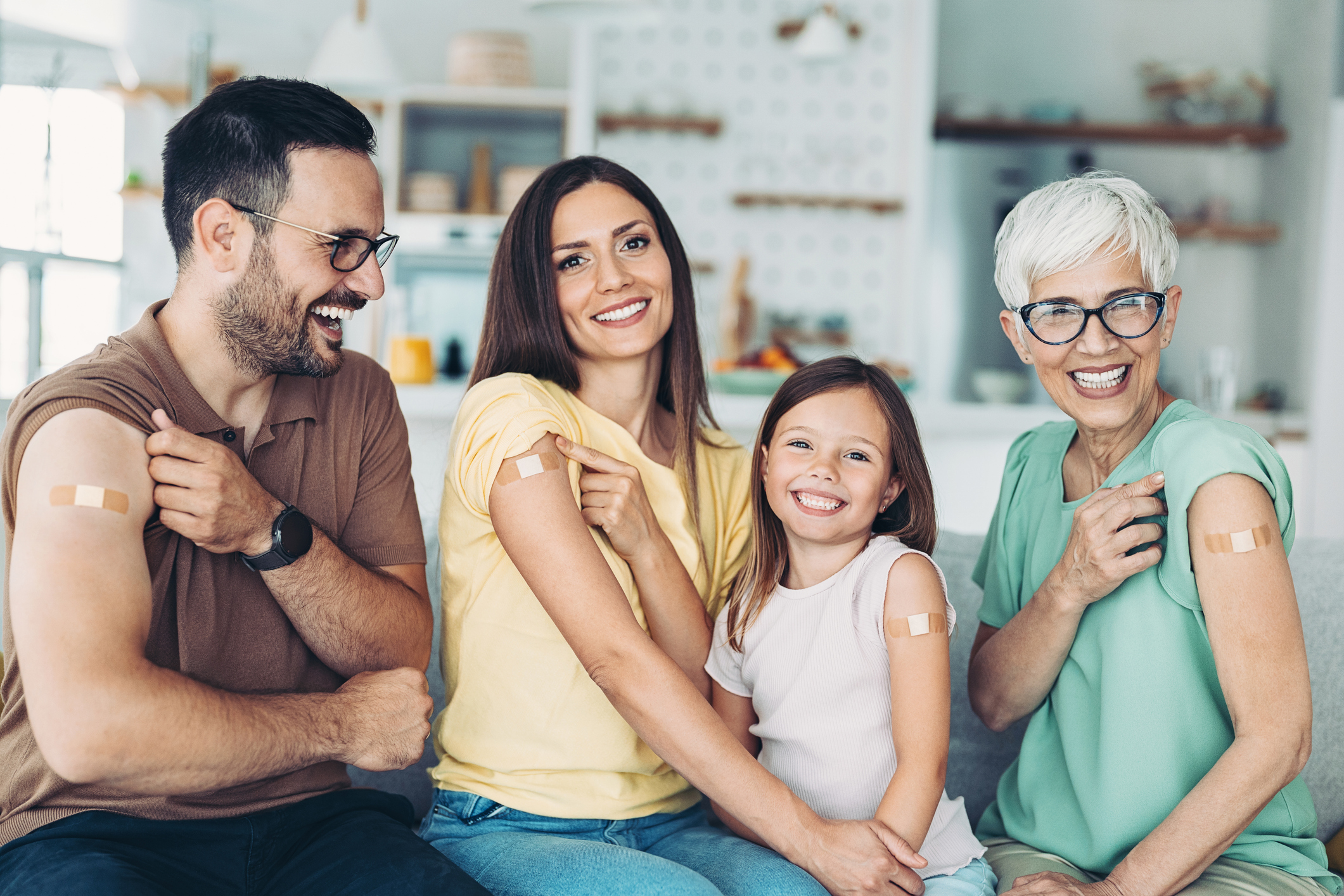 Portrait of a family with a child with adhesive bandages after covid-19 vaccination