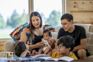 Indigenous family reading books to their children