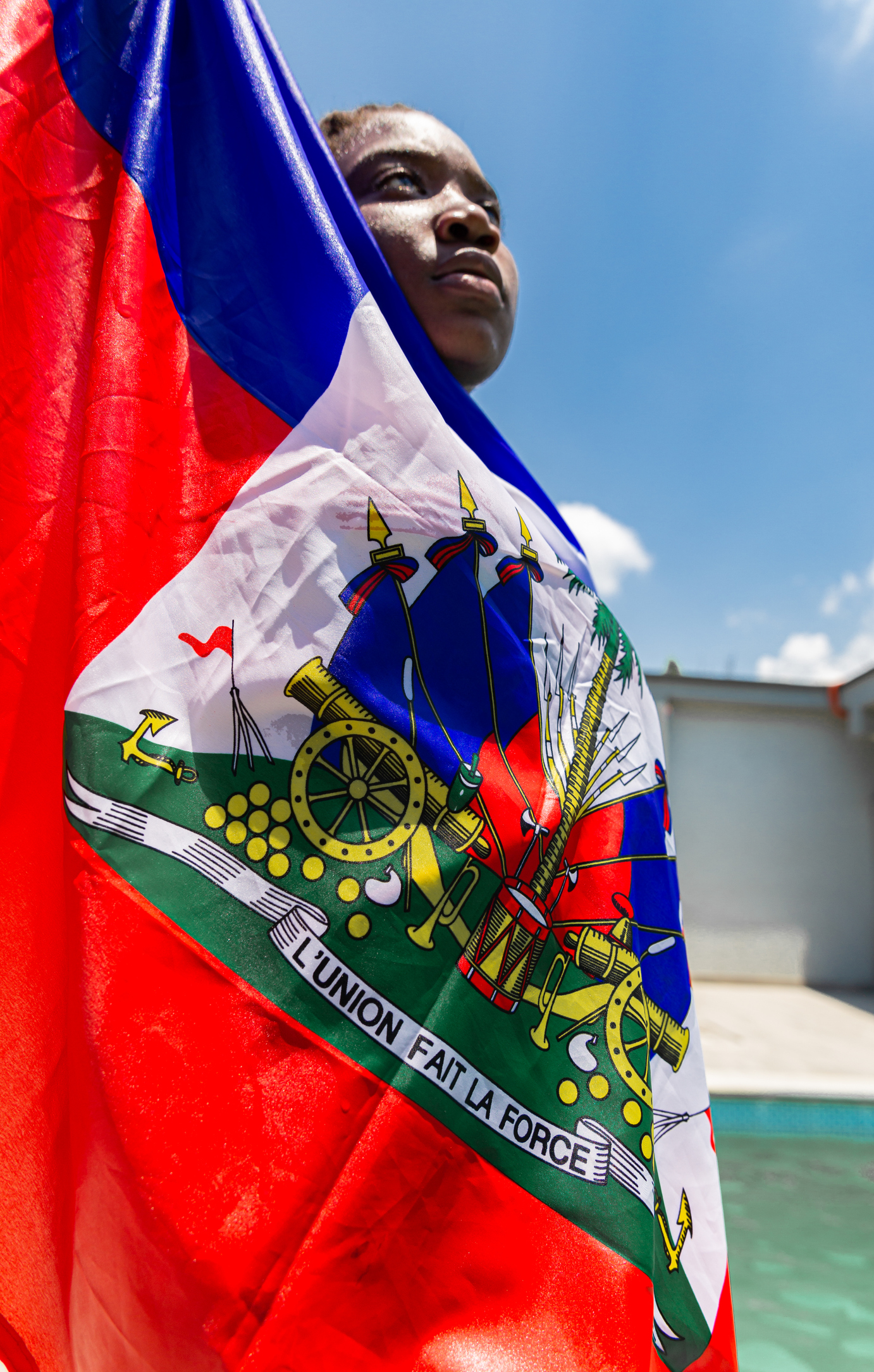 Young Haitian woman with flag